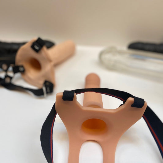 Strap-on harnas en dildo producten gepresenteerd op een neutrale achtergrond voor overzichtelijke productfotografie