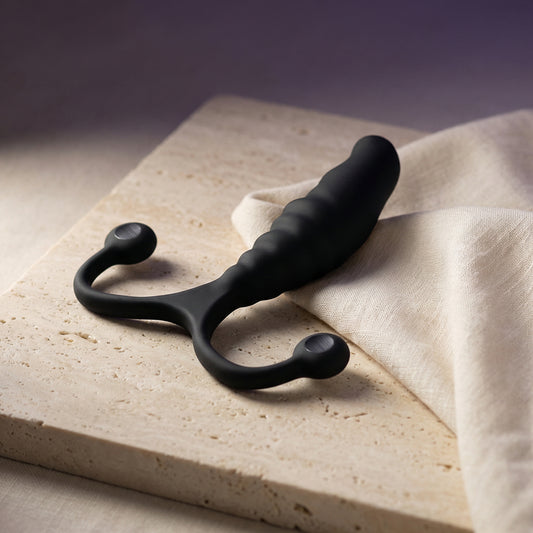 Zijaanzicht van de Aneros PSY prostaat stimulator, toont de gebogen vorm en gladde afwerking